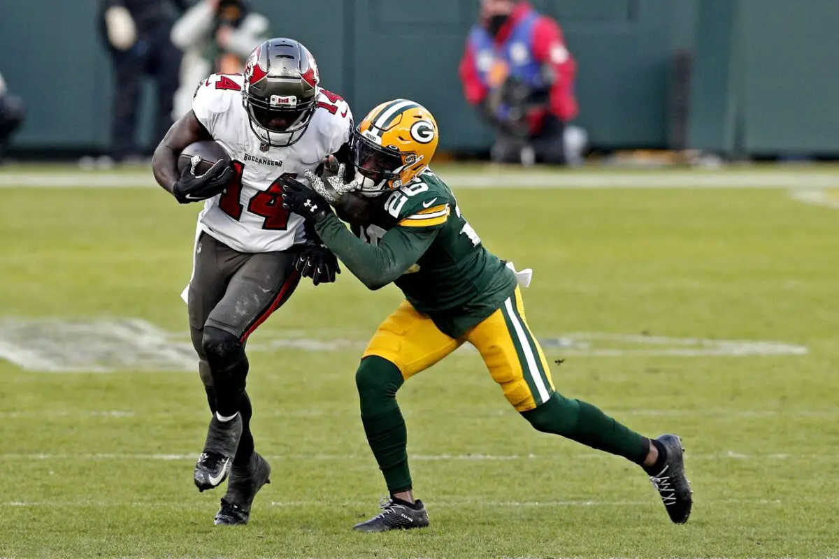 Jan 24, 2021; Green Bay, Wisconsin, USA; Tampa Bay Buccaneers wide receiver Chris Godwin (14) runs the ball against Green Bay Packers free safety Darnell Savage (26) during the second quarter in the NFC Championship Game at Lambeau Field. Mandatory Credit: Jeff Hanisch-USA TODAY Sports