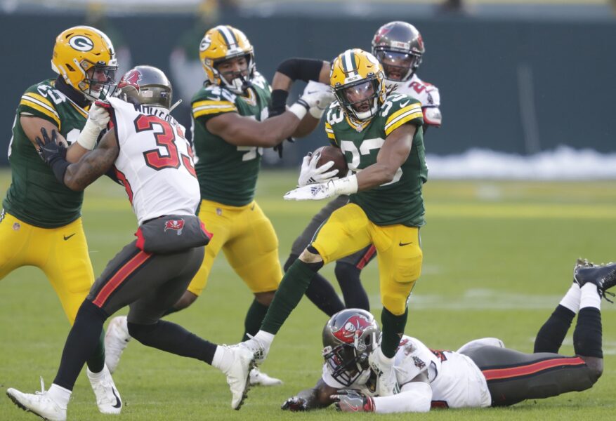 Jan 24, 2021, Green Bay, WI, USA; Green Bay Packers running back Aaron Jones (33) runs for a first down against Tampa Bay Buccaneers inside linebacker Devin White (45) during the NFC championship game. Mandatory credit: Dan Powers / Milwaukee Journal Sentinel via USA TODAY NETWORK