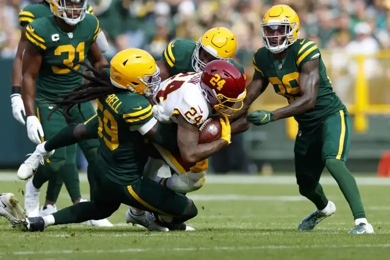 Oct 24, 2021; Green Bay, Wisconsin, USA; Washington Football Team running back Antonio Gibson (24) is tackled by Green Bay Packers linebacker De'Vondre Campbell (59) during the first quarter at Lambeau Field. Mandatory Credit: Jeff Hanisch-USA TODAY Sports