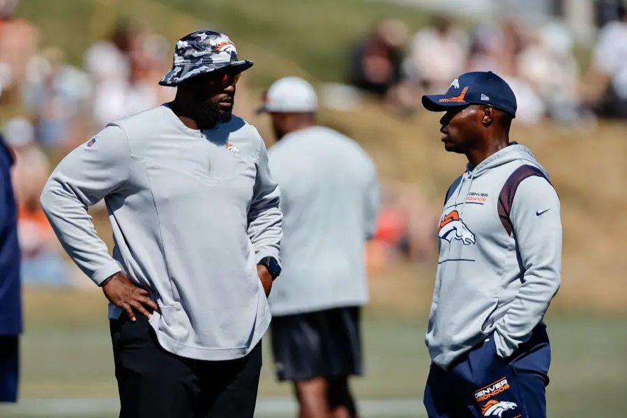 Aug 10, 2022; Englewood, CO, USA; Denver Broncos defensive line coach Marcus Dixon (L) talks with defensive coordinator Ejiro Evero (R) during training camp at the UCHealth Training Center. Mandatory Credit: Isaiah J. Downing-USA TODAY Sports (Green Bay Packers)