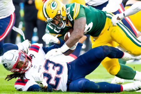 Green Bay Packers running back AJ Dillon (28) runs the ball against New England Patriots safety Kyle Dugger (23) in the second half of the game on Sunday, Oct. 2, 2022, at Lambeau Field in Green Bay, Wis. Samantha Madar/USA TODAY NETWORK-Wis.