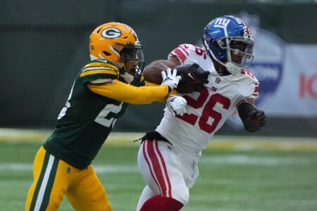 Oct 9, 2022; London, United Kingdom; New York Giants running back Saquon Barkley (26) carries the ball against Green Bay Packers cornerback Jaire Alexander (23) in the first half during an NFL International Series game at Tottenham Hotspur Stadium. Mandatory Credit: Kirby Lee-USA TODAY Sports