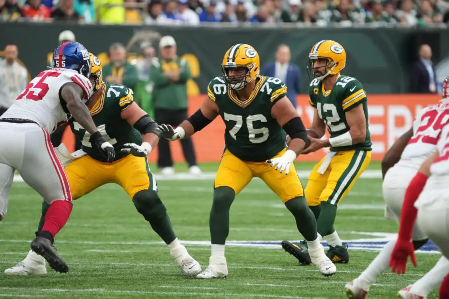 Oct 9, 2022; London, United Kingdom; Green Bay Packers guard Jon Runyan (76) blocks as quarterback Aaron Rodgers (12) drops back to pass against the New York Giants during an NFL International Series game at Tottenham Hotspur Stadium. Mandatory Credit: Kirby Lee-USA TODAY Sports