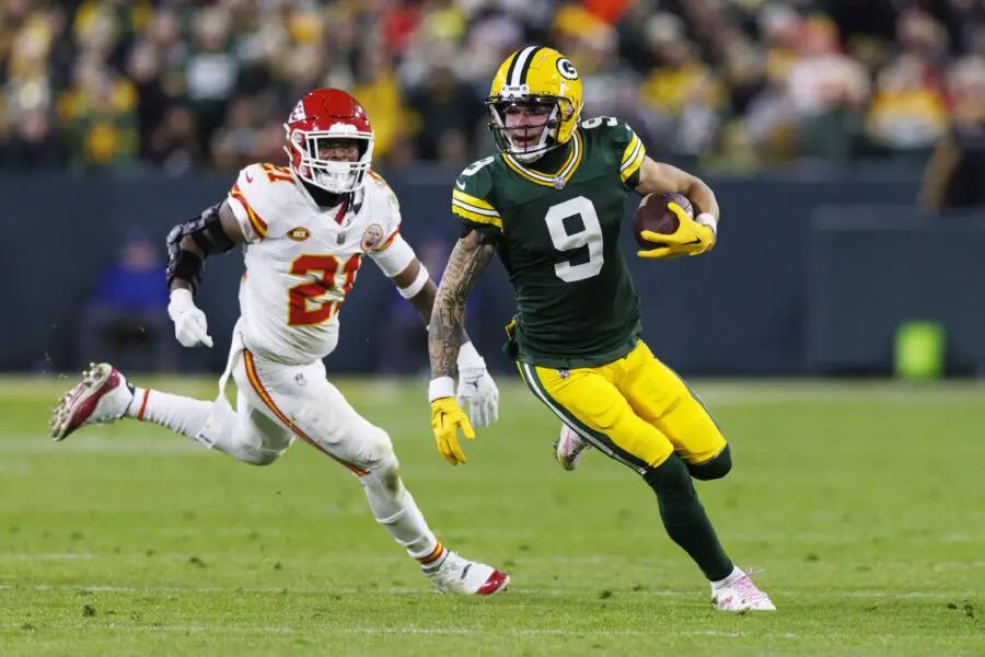 Dec 3, 2023; Green Bay, Wisconsin, USA; Green Bay Packers wide receiver Christian Watson (9) rushes with the football in front of Kansas City Chiefs safety Mike Edwards (21) during the fourth quarter at Lambeau Field. Mandatory Credit: Jeff Hanisch-USA TODAY Sports
