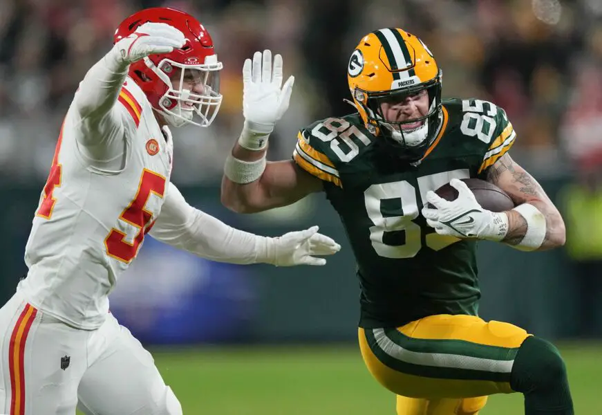 Green Bay Packers tight end Tucker Kraft (85) makes a reception for first down before being tackled by Kansas City Chiefs linebacker Leo Chenal (54) during the first quarter of their game Sunday, December 3, 2023 at Lambeau Field in Green Bay, Wisconsin.