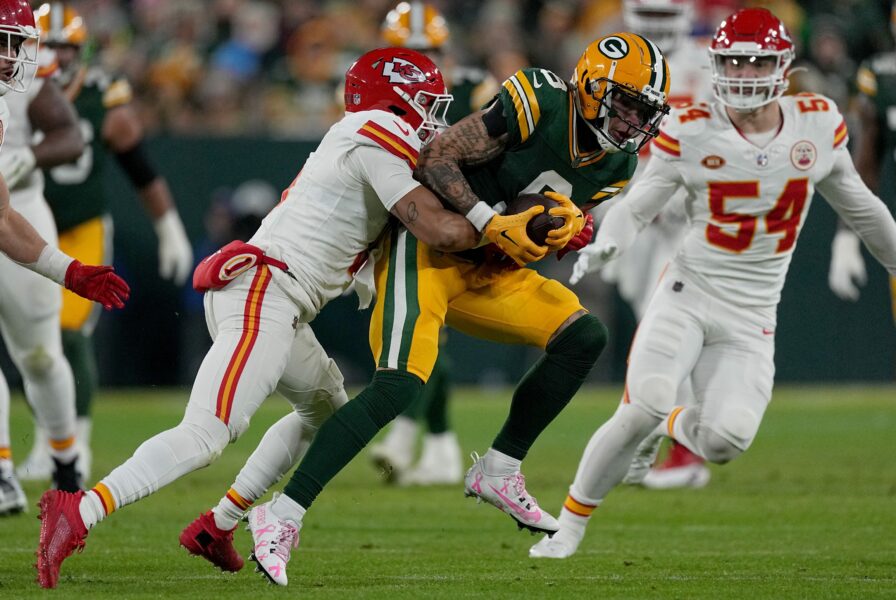 Green Bay Packers wide receiver Christian Watson (9) makes a 19-yard reception before being tackled by Kansas City Chiefs safety Bryan Cook (6) during the first quarter of their game Sunday, December 3, 2023 at Lambeau Field in Green Bay, Wisconsin. © Mark Hoffman/Milwaukee Journal Sentinel / USA TODAY NETWORK