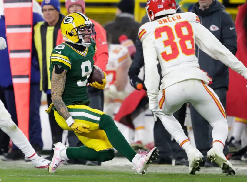 Green Bay Packers wide receiver Christian Watson (9) grabs his leg on a first down reception against Kansas City Chiefs cornerback L'Jarius Sneed (38) during their football game Sunday, December 3, 2023, at Lambeau Field in Green Bay, Wis. © Dan Powers/USA TODAY NETWORK-Wisconsin / USA TODAY NETWORK
