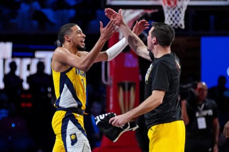 Dec 7, 2023; Las Vegas, Nevada, USA; Indiana Pacers guard Tyrese Haliburton (0) celebrates with guard T.J. McConnell (9) after beating the Milwaukee Bucks in the NBA In Season Tournament Semifinal at T-Mobile Arena. Mandatory Credit: Kyle Terada-USA TODAY Sports