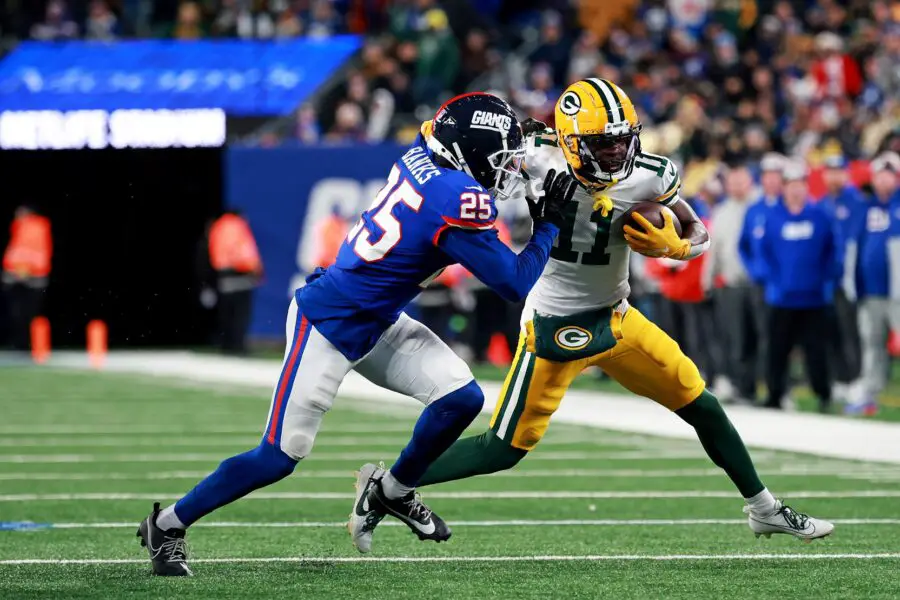 Dec 11, 2023; East Rutherford, New Jersey, USA; Green Bay Packers wide receiver Jayden Reed (11) runs the ball after a catch against New York Giants cornerback Deonte Banks (25) during the fourth quarter at MetLife Stadium. Mandatory Credit: Vincent Carchietta-USA TODAY Sports