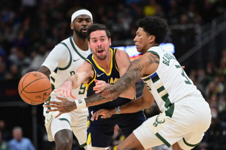 Dec 13, 2023; Milwaukee, Wisconsin, USA; Indiana Pacers guard T.J. McConnell (9) gets a pass away from Milwaukee Bucks forward Bobby Portis (9) and guard MarJon Beauchamp (3) in the first quarter at Fiserv Forum. Mandatory Credit: Benny Sieu-USA TODAY Sports
