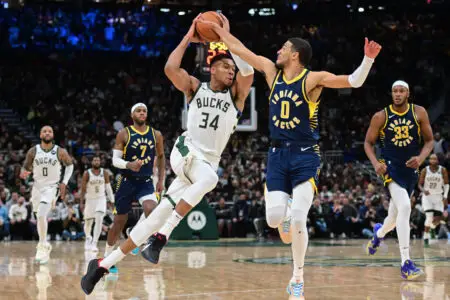 Dec 13, 2023; Milwaukee, Wisconsin, USA; Milwaukee Bucks forward Giannis Antetokounmpo (34) drives for the basket against Indiana Pacers guard Tyrese Haliburton (0) in the fourth quarter at Fiserv Forum. Mandatory Credit: Benny Sieu-USA TODAY Sports