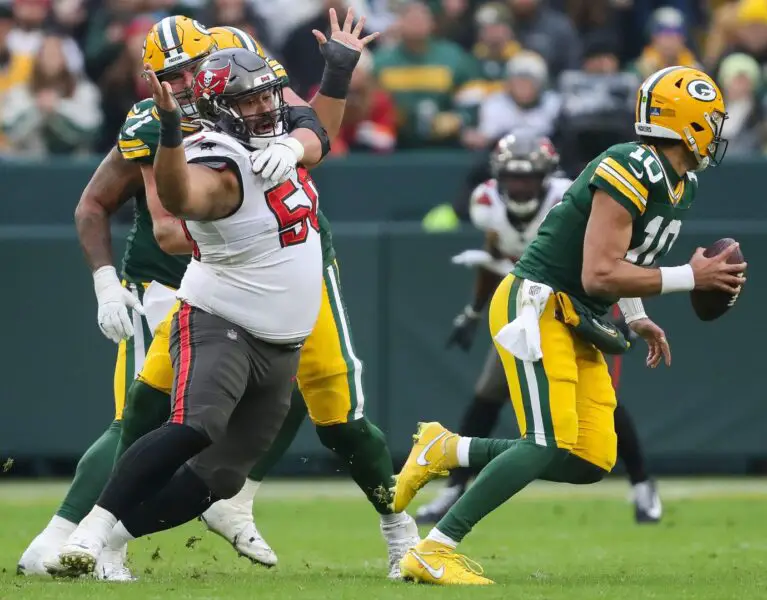 Tampa Bay Buccaneers defensive tackle Vita Vea (50) is held by Green Bay Packers center Josh Myers (71) as he rushes quarterback Jordan Love (10) on Sunday, December 17, 2023, at Lambeau Field, Wis. Tampa Bay won the game, 34-20. Tork Mason/USA TODAY NETWORK-Wisconsin