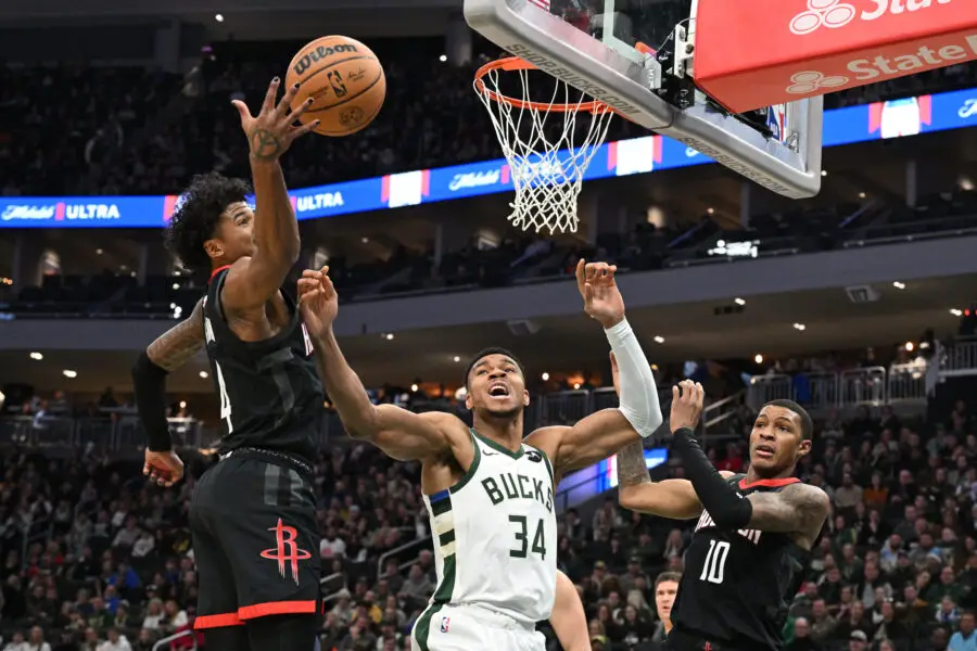 Dec 17, 2023; Milwaukee, Wisconsin, USA; Milwaukee Bucks forward Giannis Antetokounmpo (34) battles for a rebound with Houston Rockets guard Jalen Green (4) in the first half at Fiserv Forum. Mandatory Credit: Michael McLoone-USA TODAY Sports