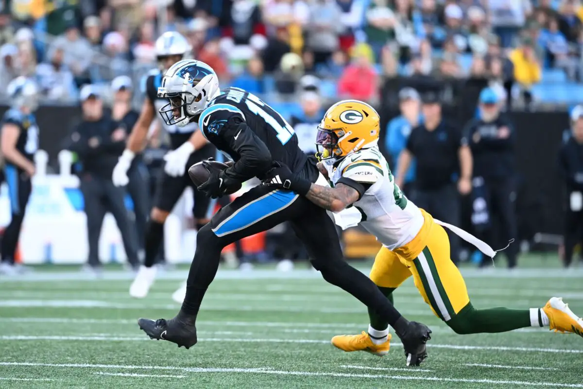 Dec 24, 2023; Charlotte, North Carolina, USA; Carolina Panthers wide receiver DJ Chark Jr. (17) catches the ball as Green Bay Packers cornerback Jaire Alexander (23) defends in the fourth quarter at Bank of America Stadium. Mandatory Credit: Bob Donnan-USA TODAY Sports