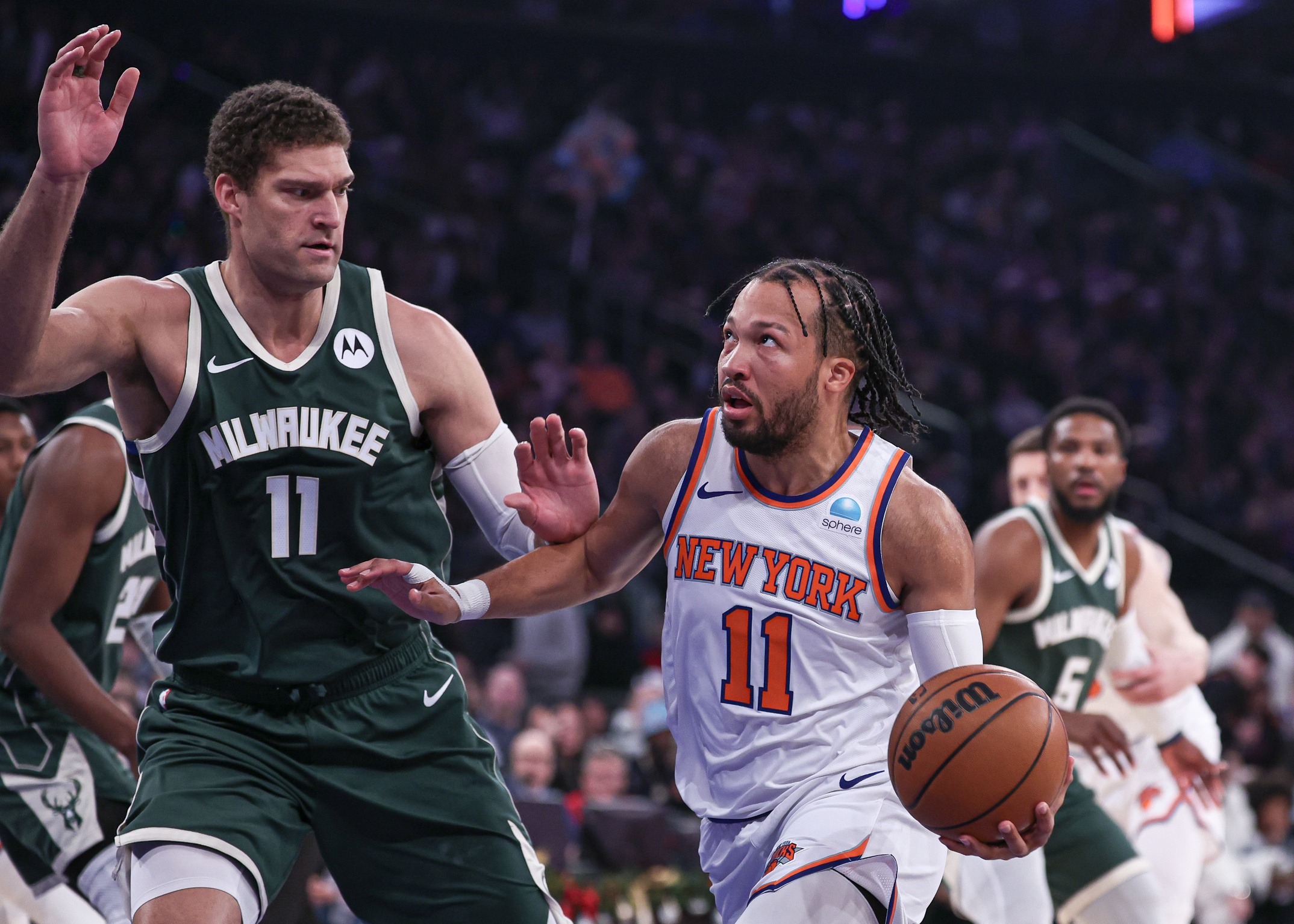 Dec 25, 2023; New York, New York, USA; New York Knicks guard Jalen Brunson (11) drives to the basket against Milwaukee Bucks center Brook Lopez (11) during the first quarter at Madison Square Garden. Mandatory Credit: Vincent Carchietta-USA TODAY Sports