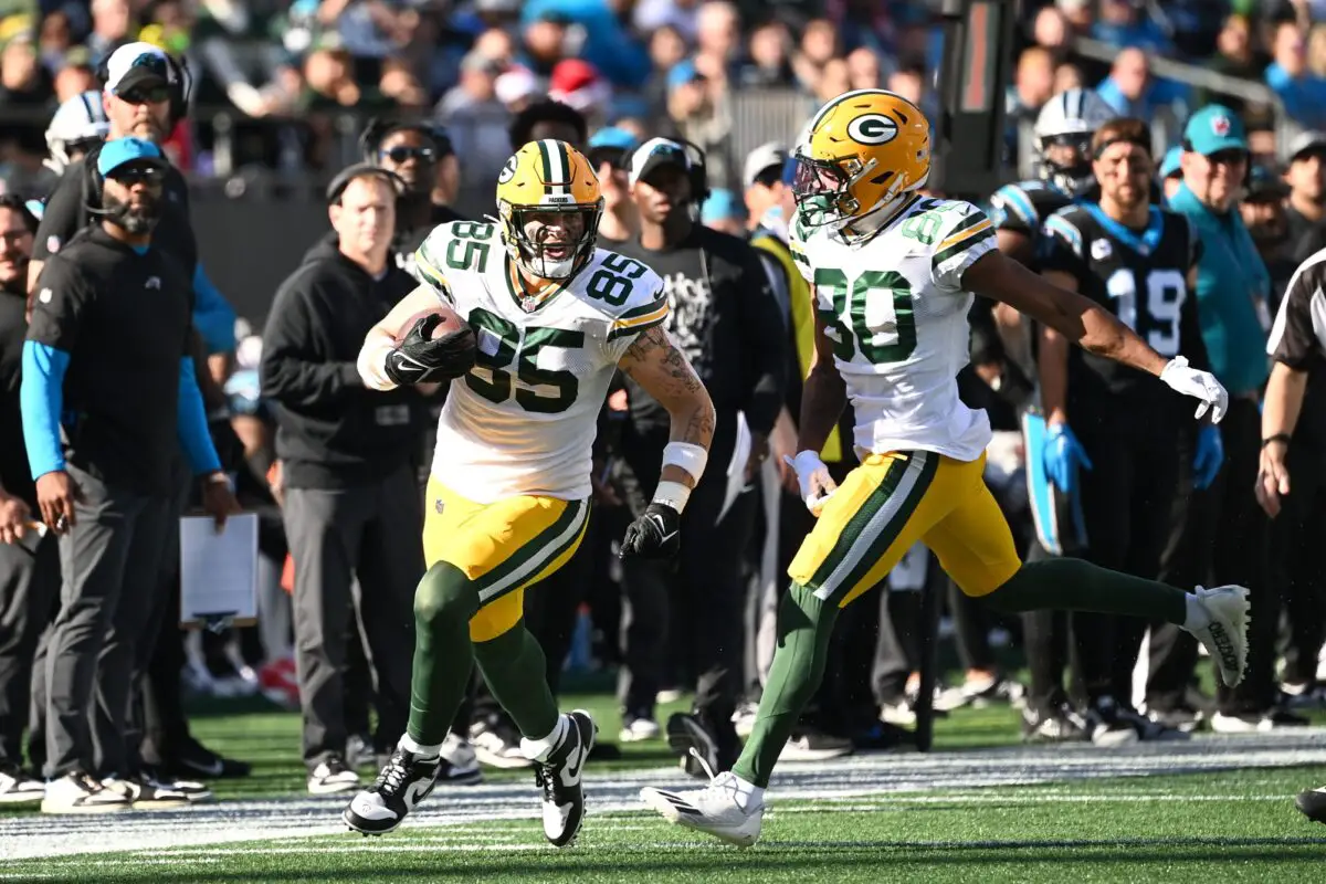 Dec 24, 2023; Charlotte, North Carolina, USA; Green Bay Packers tight end Tucker Kraft (85) with the ball as wide receiver Bo Melton (80) blocks in the first quarter at Bank of America Stadium. Mandatory Credit: Bob Donnan-USA TODAY Sports