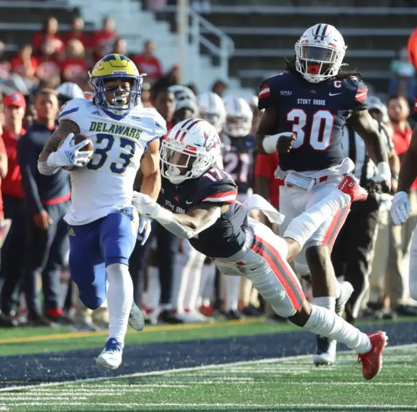 Delaware running back Dejoun Lee is dragged down by Stony Brook's Carthell Flowers-Lloyd at the end of a long run in the second quarter at Stony Brook, Saturday, Oct. 16, 2021. © William Bretzger / Delaware News Journal / USA TODAY NETWORK (Green Bay Packers)