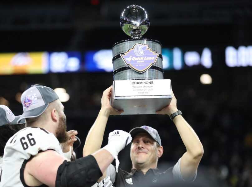 Western Michigan head coach Tim Lester accepts the  Quick Lane Bowl trophy after the Broncos' 52-24 win over Nevada on Monday, Dec. 27, 2021, at Ford Field. © Kirthmon F. Dozier / USA TODAY NETWORK (Green Bay Packers)