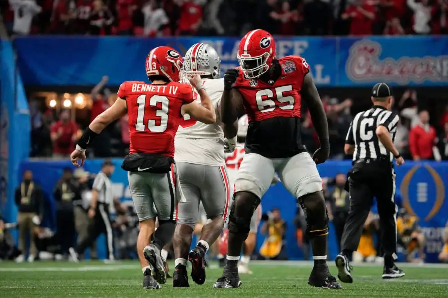 Dec 31, 2022; Atlanta, Georgia, USA;  Georgia Bulldogs quarterback Stetson Bennett (13) gets a fist pump from offensive lineman Amarius Mims (65) after a touchdown pass during the second half of the Peach Bowl against the Ohio State Buckeyes in the College Football Playoff semifinal at Mercedes-Benz Stadium. Ohio State lost 42-41. Mandatory Credit: Adam Cairns-The Columbus DispatchNcaa Football Peach Bowl Ohio State At Georgia © Adam Cairns/Columbus Dispatch / USA TODAY NETWORK (Green Bay Packers)
