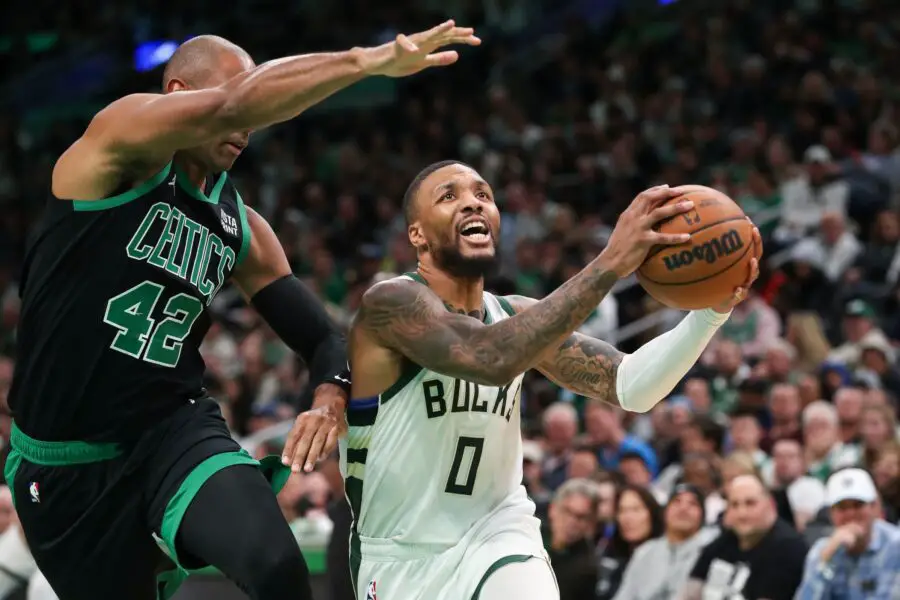 Nov 22, 2023; Boston, Massachusetts, USA; Milwaukee Bucks guard Damian Lillard (0) drives to the basket defended by Boston Celtics center Al Horford (42) during the second half at TD Garden. Mandatory Credit: Paul Rutherford-USA TODAY Sports