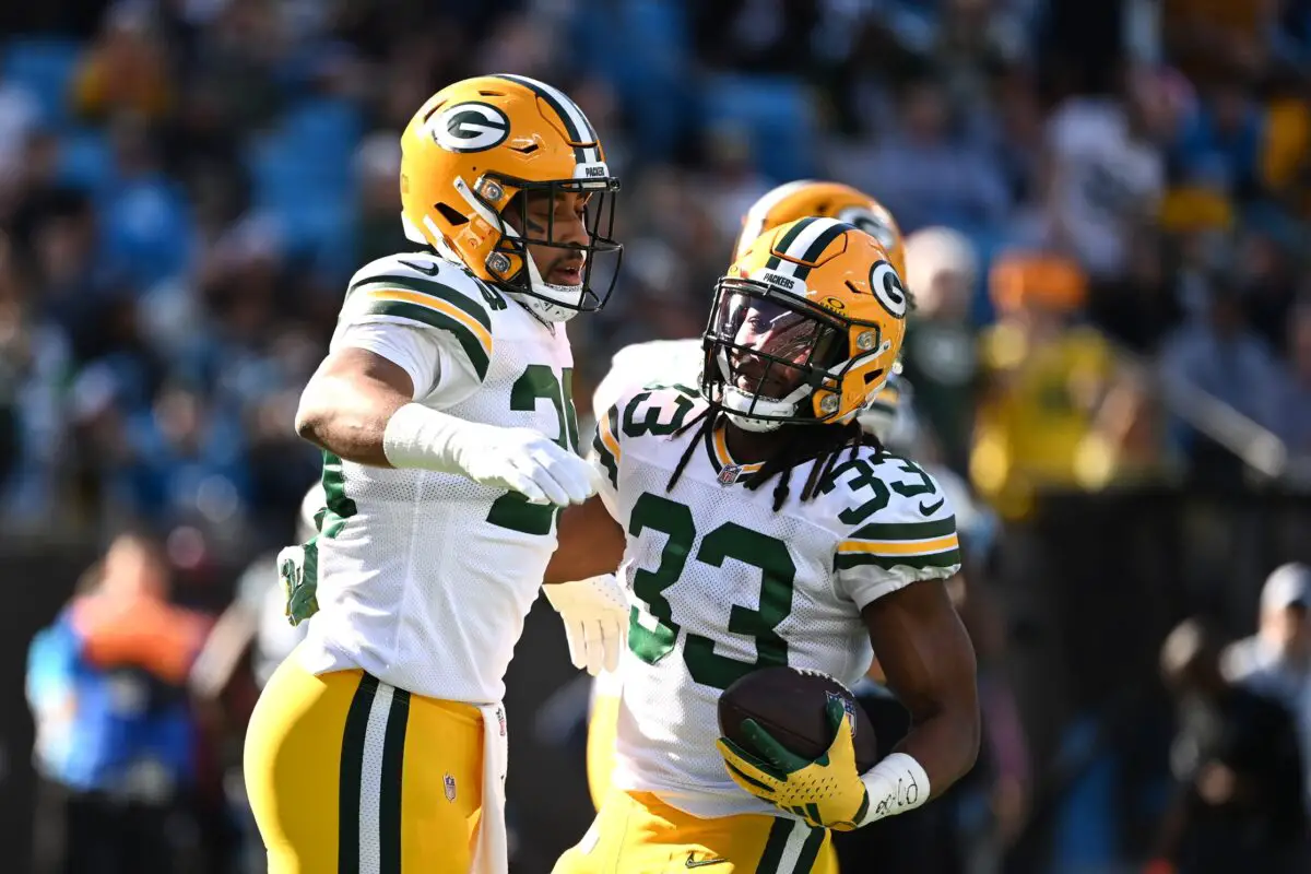 Dec 24, 2023; Charlotte, North Carolina, USA; Green Bay Packers running back AJ Dillon (28) reacts with running back Aaron Jones (33) after scoring a touchdown in the first quarter at Bank of America Stadium. Mandatory Credit: Bob Donnan-USA TODAY Sports
