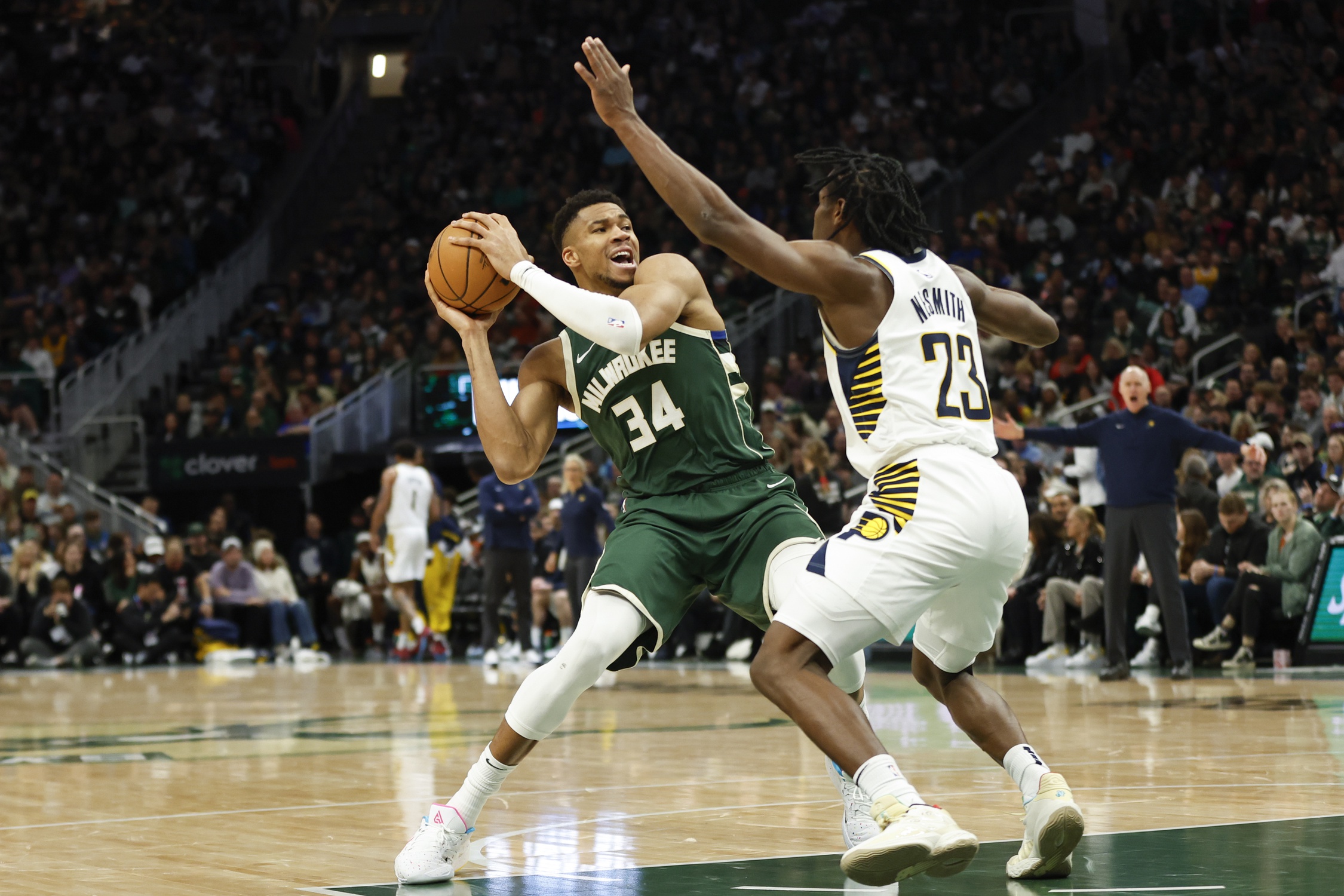 Jan 1, 2024; Milwaukee, Wisconsin, USA; Milwaukee Bucks forward Giannis Antetokounmpo (34) is defended by Indiana Pacers forward Aaron Nesmith (23) during the first half at Fiserv Forum. Mandatory Credit: Kamil Krzaczynski-USA TODAY Sports
