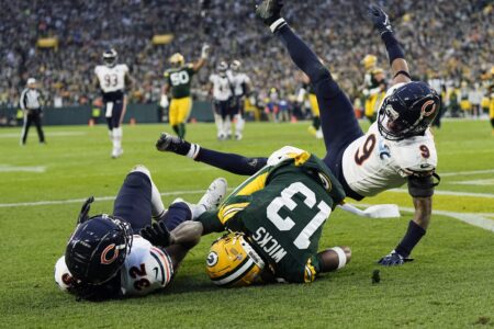 Jan 7, 2024; Green Bay, Wisconsin, USA; Green Bay Packers wide receiver Dontayvion Wicks (13) catches a pass to score a touchdown between Chicago Bears cornerback Terell Smith (32) and defensive back Jaquan Brisker (9) during the second quarter at Lambeau Field. Mandatory Credit: Jeff Hanisch-USA TODAY Sports