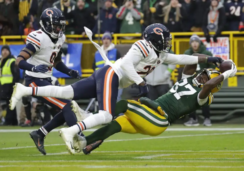 Jan 7, 2024; Green Bay, Wisconsin, USA; Chicago Bears cornerback Tyrique Stevenson (29) breaks up a potential touchdown reception against Green Bay Packers wide receiver Romeo Doubs (87) during the first half at Lambeau Field. Mandatory Credit: Dan Powers-USA TODAY Sports