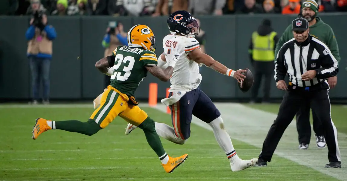 Green Bay Packers cornerback Jaire Alexander (23) runs Chicago Bears quarterback Justin Fields (1) out of bounds during the third quarter of their game Sunday, January 7, 2024 at Lambeau Field in Green Bay, Wisconsin. The Green Bay Packers beat the Chicago Bears 17-9.