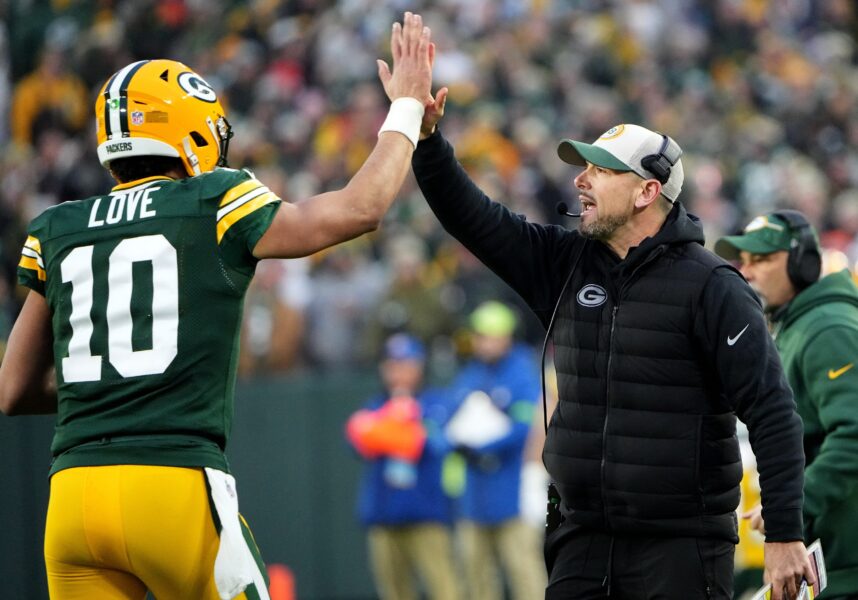 Green Bay Packers quarterback Jordan Love (10) high fives head coach Matt LaFleur after throwing a touchdown pass during the second quarter of their game against the Chicago Bear Sunday, January 7, 2024 at Lambeau Field in Green Bay, Wisconsin.