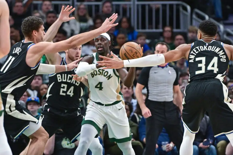 Jan 11, 2024; Milwaukee, Wisconsin, USA; Boston Celtics guard Jrue Holiday (4) gets pressure from Milwaukee Bucks center Brook Lopez (11), guard Pat Connaughton (24) and forward Giannis Antetokounmpo (34) in the second quarter at Fiserv Forum. Mandatory Credit: Benny Sieu-USA TODAY Sports