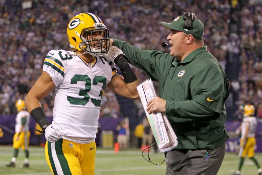 Oct 27, 2013; Minneapolis, MN, USA; Green Bay Packers cornerback Micah Hyde (left) celebrates his touchdown with head coach Mike McCarthy (right) during the second quarter against the Minnesota Vikings at Mall of America Field at H.H.H. Metrodome. Mandatory Credit: Brace Hemmelgarn-USA TODAY Sports