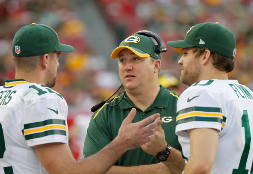 Dec 21, 2014; Tampa, FL, USA; Green Bay Packers quarterback Aaron Rodgers (12), quarterbacks coach Alex Van Pelt and quarterback Matt Flynn (10) talk during the second half against the Tampa Bay Buccaneers at Raymond James Stadium. Green Bay Packers defeated the Tampa Bay Buccaneers 20-3. Mandatory Credit: Kim Klement-USA TODAY Sports