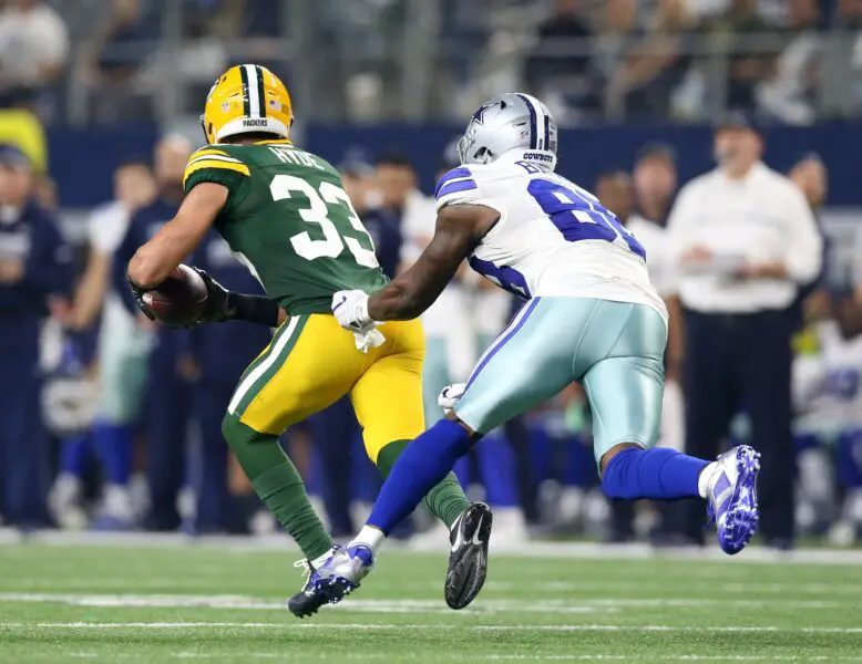 Jan 15, 2017; Arlington, TX, USA; Green Bay Packers strong safety Micah Hyde (33) runs the ball against Dallas Cowboys wide receiver Dez Bryant (88) after an interception during the third quarter in the NFC Divisional playoff game at AT&T Stadium. Mandatory Credit: Matthew Emmons-USA TODAY Sports