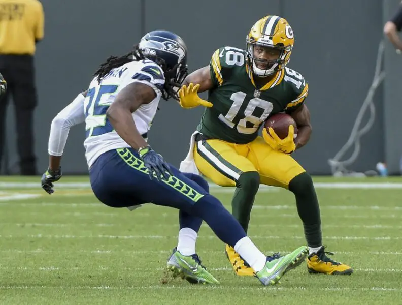Sep 10, 2017; Green Bay, WI, USA; Green Bay Packers wide receiver Randall Cobb (18) tries to break a tackle by Seattle Seahawks cornerback Richard Sherman (25) after making a ctach in the fourth quarter at Lambeau Field. Mandatory Credit: Benny Sieu-USA TODAY Sports