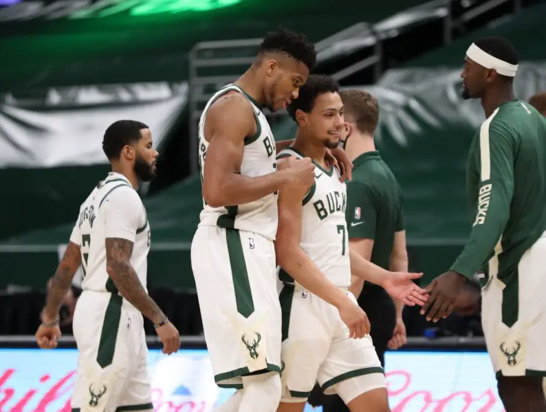 Jan 1, 2021; Milwaukee, WI, USA; Milwaukee Bucks forward Giannis Antetokounmpo (34) and guard Bryn Forbes (7) react during the game against the Chicago Bulls at the Bradley Center. Mandatory Credit: Nick Monroe/Handout Photo-USA TODAY Sports