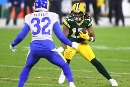 Jan 16, 2021; Green Bay, Wisconsin, USA; Green Bay Packers wide receiver Davante Adams (17) runs after a catch as Los Angeles Rams safety Jordan Fuller (32) defends during the first half of a NFC Divisional Round playoff game at Lambeau Field. Mandatory Credit: Mark J. Rebilas-USA TODAY Sports