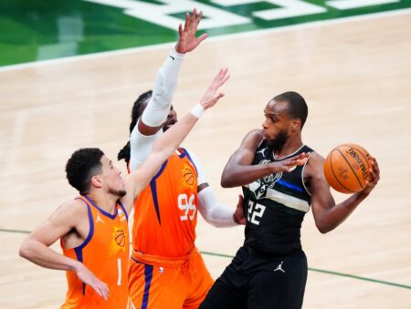 Jul 20, 2021; Milwaukee, Wisconsin, USA; Milwaukee Bucks forward Khris Middleton (22) defended by Phoenix Suns forward Jae Crowder (99) and guard Devin Booker (1) during game six of the 2021 NBA Finals at Fiserv Forum. Mandatory Credit: Mark J. Rebilas-USA TODAY Sports