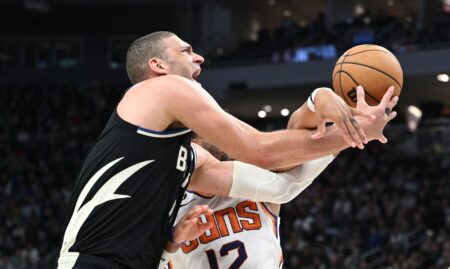 Feb 26, 2023; Milwaukee, Wisconsin, USA; Milwaukee Bucks center Brook Lopez (11) is fouled as he drives to the basket against Phoenix Suns forward Ish Wainright (12) in the second half at Fiserv Forum. Mandatory Credit: Michael McLoone-USA TODAY Sports