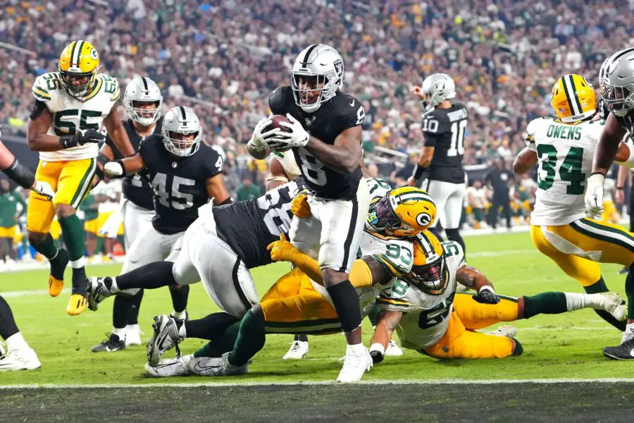 Oct 9, 2023; Paradise, Nevada, USA; Las Vegas Raiders running back Josh Jacobs (8) scores a touchdown against the Green Bay Packers during the fourth quarter at Allegiant Stadium. Mandatory Credit: Stephen R. Sylvanie-USA TODAY Sports