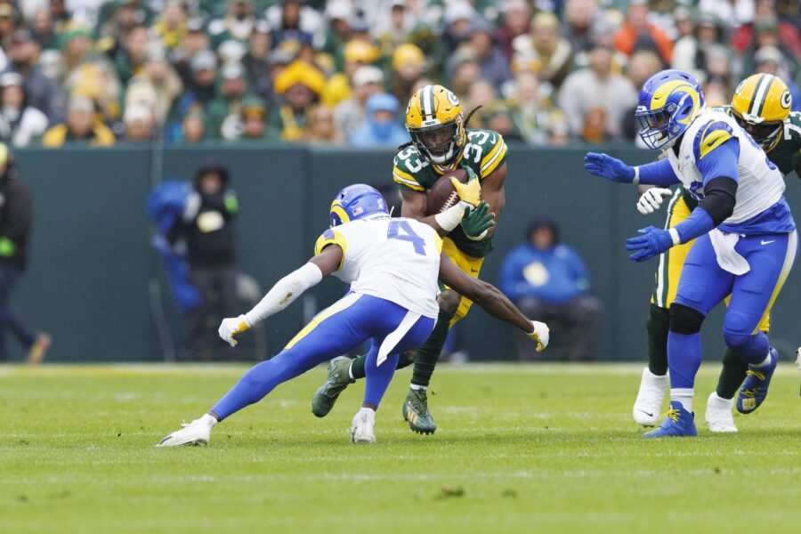 Nov 5, 2023; Green Bay, Wisconsin, USA; Green Bay Packers running back Aaron Jones (33) is tackled by Los Angeles Rams defensive back Jordan Fuller (4) during the first quarter at Lambeau Field. Mandatory Credit: Jeff Hanisch-USA TODAY Sports