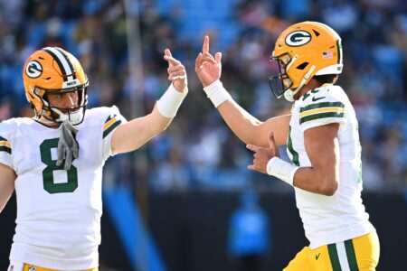 Dec 24, 2023; Charlotte, North Carolina, USA; Green Bay Packers quarterback Jordan Love (10) reacts with quarterback Sean Clifford (8) after scoring a touchdown in the second quarter at Bank of America Stadium. Mandatory Credit: Bob Donnan-USA TODAY Sports