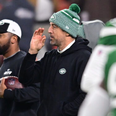 Dec 28, 2023; Cleveland, Ohio, USA; New York Jets quarterback Aaron Rodgers (center) gestures before the game between the Cleveland Browns and the Jets at Cleveland Browns Stadium. Mandatory Credit: Ken Blaze-USA TODAY Sports