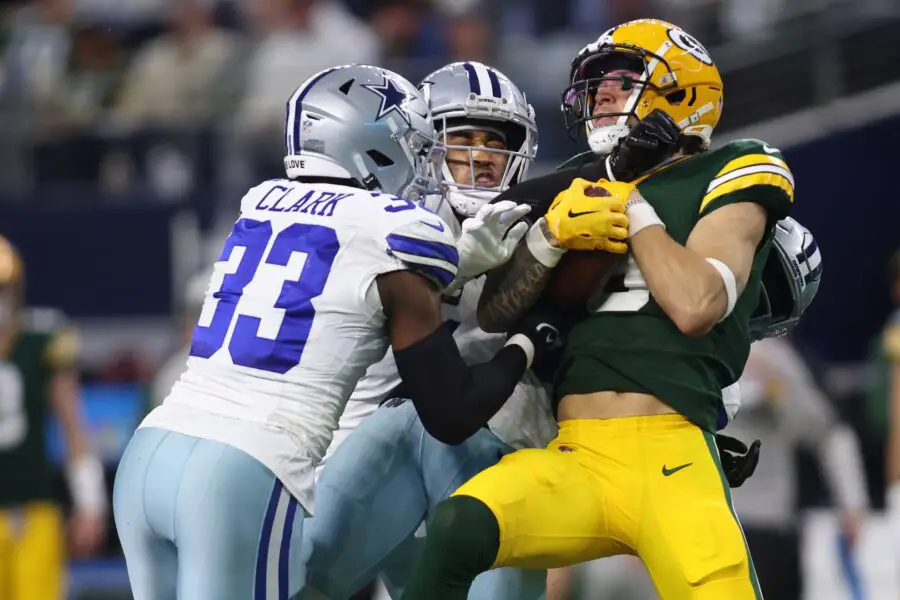 Jan 14, 2024; Arlington, Texas, USA; Green Bay Packers wide receiver Christian Watson (9) catches a pass against Dallas Cowboys linebacker Damone Clark (33) during the first half for the 2024 NFC wild card game at AT&T Stadium. Mandatory Credit: Tim Heitman-USA TODAY Sports