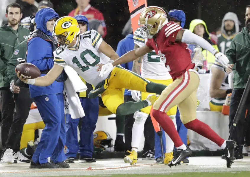 Jan 20, 2024; Santa Clara, CA, USA; Green Bay Packers quarterback Jordan Love (10) is knocked out of bounds by San Francisco 49ers cornerback Deommodore Lenoir (2) in a 2024 NFC divisional round game at Levi's Stadium. Mandatory Credit: Dan Powers-USA TODAY Sports