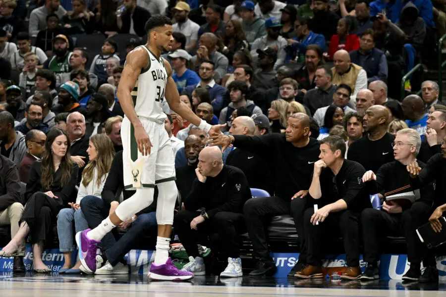 Feb 3, 2024; Dallas, Texas, USA; Milwaukee Bucks head coach Doc Rivers slaps the hand of forward Giannis Antetokounmpo (34) as he walks off the court during the second quarter at the American Airlines Center. Mandatory Credit: Jerome Miron-USA TODAY Sports