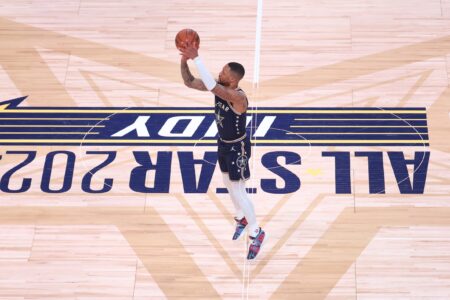 Feb 18, 2024; Indianapolis, Indiana, USA; Eastern Conference guard Damian Lillard (0) of the Milwaukee Bucks makes a three point basket from half court against the Western Conference All-Stars during the third quarter in the 73rd NBA All Star game at Gainbridge Fieldhouse. Mandatory Credit: Trevor Ruszkowski-USA TODAY Sports