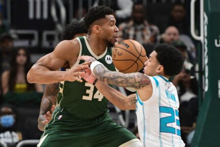 Feb 27, 2024; Milwaukee, Wisconsin, USA; Milwaukee Bucks forward Giannis Antetokounmpo (34) and Charlotte Hornets guard Tre Mann (23) battle for a loose ball in the first quarter at Fiserv Forum. Mandatory Credit: Benny Sieu-USA TODAY Sports