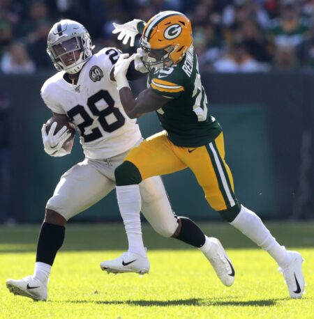 Green Bay Packers cornerback Will Redmond tackles Oakland Raiders running back Josh Jacobs on October 20, 2019, at Lambeau Field in Green Bay, Wis. © USA TODAY NETWORK-Wis, Appleton Post-Crescent via Imagn Content Services, LLC