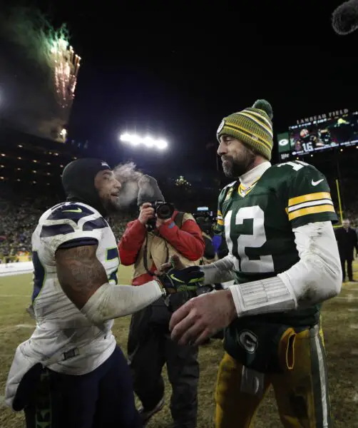 Jan 12, 2020; Green Bay, WI, USA; Green Bay Packers quarterback Aaron Rodgers (12) greets Seattle Seahawks defensive back Quandre Diggs (37) after a NFC Divisional Round playoff football game at Lambeau Field. Mandatory Credit: Jeff Hanisch-USA TODAY Sports